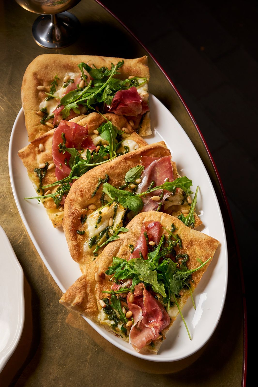 Pinsa romana with prosciutto, pesto and rocket