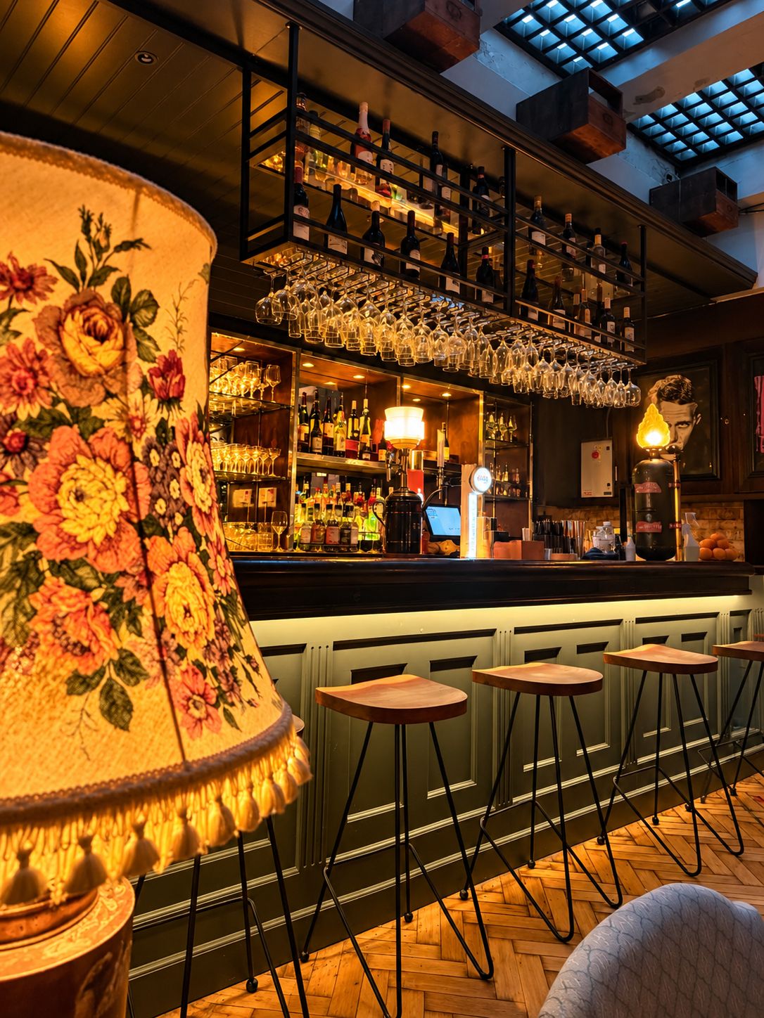 The bar past a vintage floral lamp