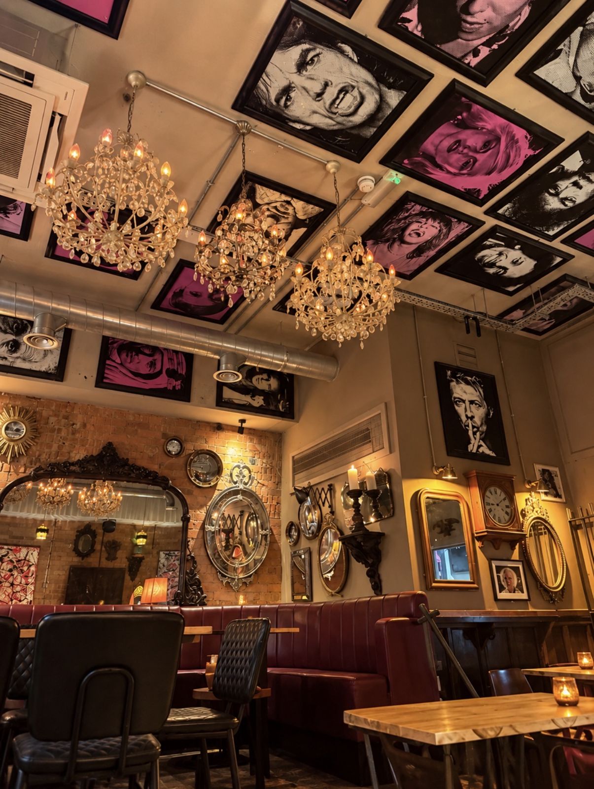 Chandeliers beneath a ceiling of rock and roll portraits